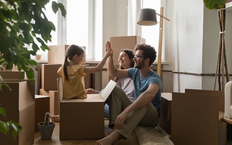 Family moving into new house sitting with boxing 